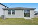Backyard features new central air conditioning unit, a small lawn, and sliding glass door at 14061 Crutchfield Ct, Parrish, FL 34219