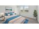 Stylish bedroom featuring a bed with blue accents and a window with natural light at 14061 Crutchfield Ct, Parrish, FL 34219