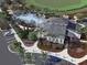 Aerial view of community clubhouse with a resort-style pool and lush landscaping at 14061 Crutchfield Ct, Parrish, FL 34219