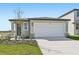 Charming single-story home featuring a large white garage door and neutral colored exterior paint at 14061 Crutchfield Ct, Parrish, FL 34219