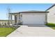 Charming single-story home featuring a large white garage door and neutral colored exterior paint at 14061 Crutchfield Ct, Parrish, FL 34219