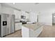 Modern kitchen with white cabinets, granite countertops, and stainless steel appliances at 14061 Crutchfield Ct, Parrish, FL 34219