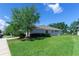 Spacious backyard with lush green grass and mature trees, overlooking a serene pond, perfect for outdoor enjoyment at 14230 Cattle Egret Pl, Lakewood Ranch, FL 34202