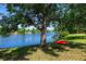 Idyllic backyard setting with a scenic lake view and a charming tree swing, perfect for relaxing and enjoying nature at 14230 Cattle Egret Pl, Lakewood Ranch, FL 34202