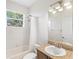Bathroom with single sink vanity, tiled shower, and natural light at 14230 Cattle Egret Pl, Lakewood Ranch, FL 34202
