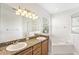 Bathroom with double sink vanity, large mirror, tub, and walk-in shower at 14230 Cattle Egret Pl, Lakewood Ranch, FL 34202