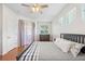 Cozy bedroom features hardwood floors, natural lighting, and neutral decor at 14230 Cattle Egret Pl, Lakewood Ranch, FL 34202