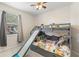 Fun bedroom featuring a bunk bed with a slide and a ceiling fan with lights at 14230 Cattle Egret Pl, Lakewood Ranch, FL 34202