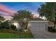 Charming single-story home with a well-manicured lawn, mature landscaping, and an attached two-car garage at 14230 Cattle Egret Pl, Lakewood Ranch, FL 34202