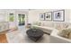 Bright living room featuring a white sofa, modern art, and sliding glass doors to the outside at 14230 Cattle Egret Pl, Lakewood Ranch, FL 34202