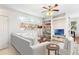 Inviting living room features a white sofa, a bookshelf, and plenty of natural light at 14230 Cattle Egret Pl, Lakewood Ranch, FL 34202