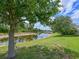 Scenic backyard view featuring lush landscaping and a tranquil pond view, perfect for relaxation at 16711 Rivers Reach Blvd, Parrish, FL 34219