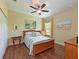 Cozy bedroom with hardwood floors, a ceiling fan, and a comfortable bed, creating a welcoming space at 16711 Rivers Reach Blvd, Parrish, FL 34219
