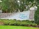 River's Reach community entrance with stone and stucco sign, mature landscaping and well manicured lawn at 16711 Rivers Reach Blvd, Parrish, FL 34219