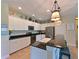 Bright kitchen with white cabinetry, granite countertops, stainless steel appliances, and a breakfast bar at 16711 Rivers Reach Blvd, Parrish, FL 34219