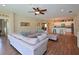 Open concept living area with wood floors, comfortable seating, and a view of the kitchen at 16711 Rivers Reach Blvd, Parrish, FL 34219