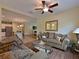 Comfortable living room with hardwood floors, cozy sofas, and an open floor plan leading to the kitchen at 16711 Rivers Reach Blvd, Parrish, FL 34219