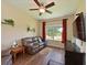 Cozy seating area with hardwood floors, a leather sofa, and ample natural light at 16711 Rivers Reach Blvd, Parrish, FL 34219