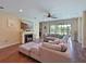 Bright and cozy living room with a fireplace, plush seating, and a view of the water at 16711 Rivers Reach Blvd, Parrish, FL 34219
