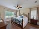 Charming main bedroom with hardwood floors, decorative ceiling fan, and plenty of natural light from the windows at 16711 Rivers Reach Blvd, Parrish, FL 34219