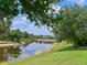 Waterfront property featuring a serene pond and well-maintained landscaping, offering a peaceful retreat at 16711 Rivers Reach Blvd, Parrish, FL 34219
