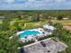 Aerial view of a sparkling community pool and recreational area surrounded by lush landscaping at 16711 Rivers Reach Blvd, Parrish, FL 34219