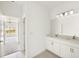 Bright bathroom with dual sinks and a connecting door to the bedroom at 16849 Castoro Dr, Port Charlotte, FL 33953