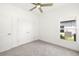 Neutral bedroom with a ceiling fan, large window and a double-doored closet at 16849 Castoro Dr, Port Charlotte, FL 33953