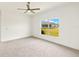 Spacious bedroom with neutral carpet and a window providing natural light at 16849 Castoro Dr, Port Charlotte, FL 33953
