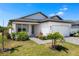 Beautifully landscaped single-Gathering home with lush greenery and a paved walkway leading to the front door at 16849 Castoro Dr, Port Charlotte, FL 33953