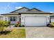 Charming single-story home featuring a well-manicured lawn, paved driveway, and a two-car garage at 16849 Castoro Dr, Port Charlotte, FL 33953