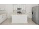 Modern kitchen with stainless steel appliances, center island, and sleek white cabinetry at 16849 Castoro Dr, Port Charlotte, FL 33953