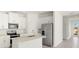 Modern kitchen featuring a center island, stainless steel appliances, and white cabinetry, creating a clean aesthetic at 16849 Castoro Dr, Port Charlotte, FL 33953