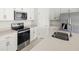 Modern kitchen showcasing stainless steel appliances and stylish white cabinetry at 16849 Castoro Dr, Port Charlotte, FL 33953