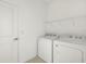 White laundry machines are positioned in the bright laundry room at 16849 Castoro Dr, Port Charlotte, FL 33953