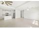 Spacious open floor plan with neutral tile flooring, seamlessly connecting the living area and kitchen at 16849 Castoro Dr, Port Charlotte, FL 33953