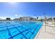 Bright community pool with swimming lanes, lifeguard chair, and modern amenities under a sunny sky at 16849 Castoro Dr, Port Charlotte, FL 33953