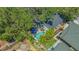 Aerial view of a backyard featuring a refreshing pool, patio area, and lush landscaping at 1742 9Th St, Sarasota, FL 34236