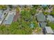 Aerial shot of a home featuring mature trees, a private pool, and fenced yard at 1742 9Th St, Sarasota, FL 34236