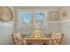 Bright breakfast nook featuring rattan chairs and a charming wooden table by a sunny window at 1742 9Th St, Sarasota, FL 34236