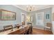 Well-lit dining room with hardwood floors, chandelier, and view of the yard through the window at 1742 9Th St, Sarasota, FL 34236