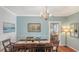 Bright dining room featuring hardwood floors, chandelier, and view into an adjacent room at 1742 9Th St, Sarasota, FL 34236