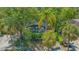 Charming cottage-style home surrounded by mature trees and lush tropical landscaping at 1742 9Th St, Sarasota, FL 34236