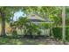 Charming home featuring a well-kept lawn, lush trees, and classic architecture, offering serene suburban living at 1742 9Th St, Sarasota, FL 34236