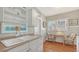 A bright kitchen featuring open shelving, a double sink, and a small table with seating at 1742 9Th St, Sarasota, FL 34236