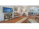 Cozy living room with hardwood floors, entertainment center, and open view to the dining room at 1742 9Th St, Sarasota, FL 34236