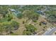 Scenic aerial view of a park featuring walking paths, tennis courts, and a tranquil pond at 1742 9Th St, Sarasota, FL 34236