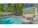 Sparkling pool with brick patio and lush tropical landscaping create a private backyard oasis at 1742 9Th St, Sarasota, FL 34236
