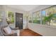 Bright sunroom with white trim, wood floors, multiple windows, and wicker furniture, offering a cozy retreat at 1742 9Th St, Sarasota, FL 34236