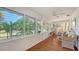 Relaxing sunroom with wood floors, wicker furniture, and bright windows, creating a tranquil space to unwind at 1742 9Th St, Sarasota, FL 34236